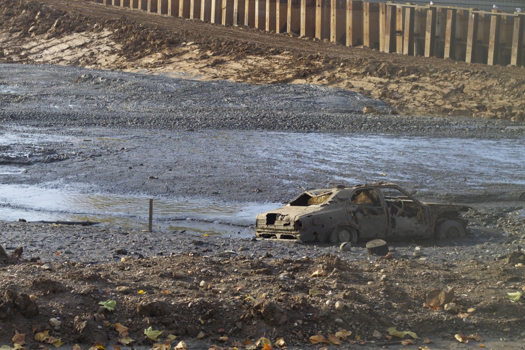 car in the drained pond
