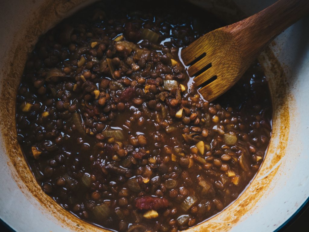 stirring vegan lentil stew