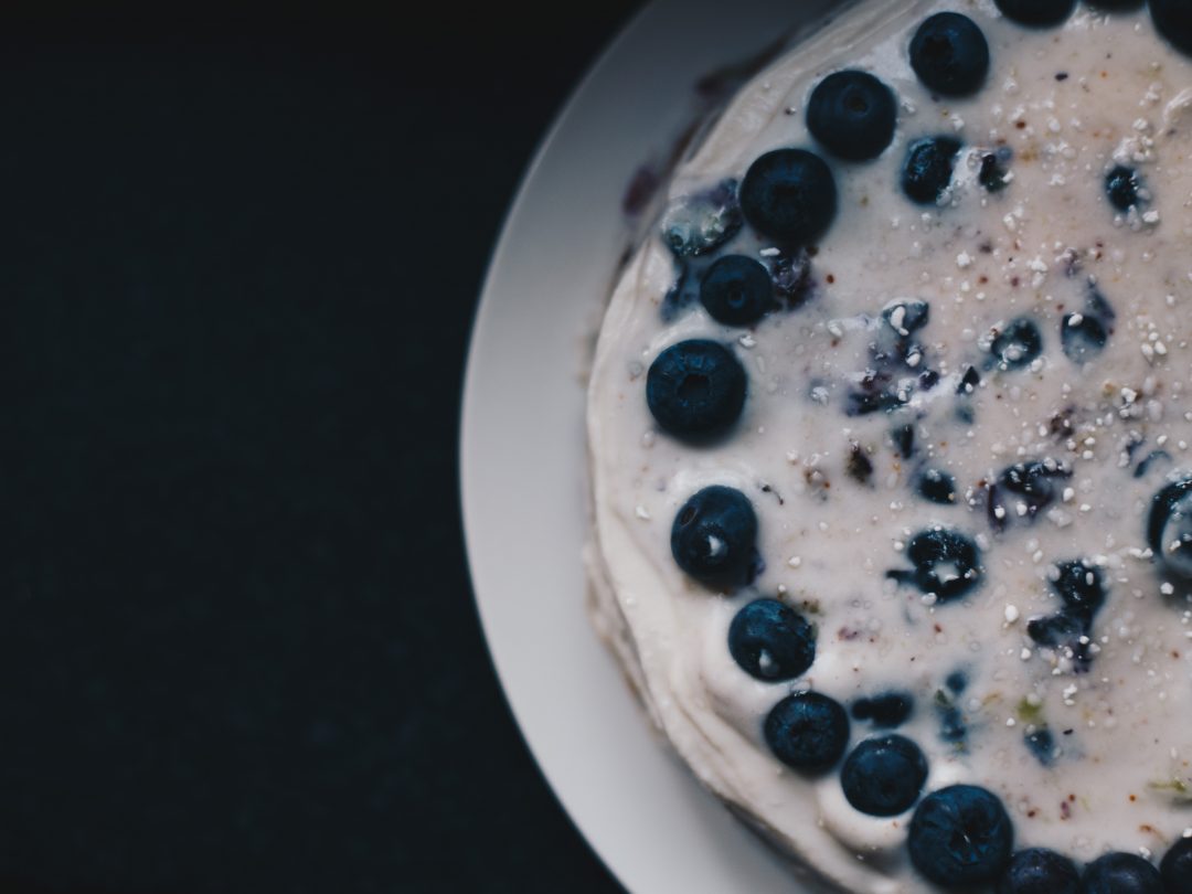 vegan lemon and blueberry cake with coconut frosting up close