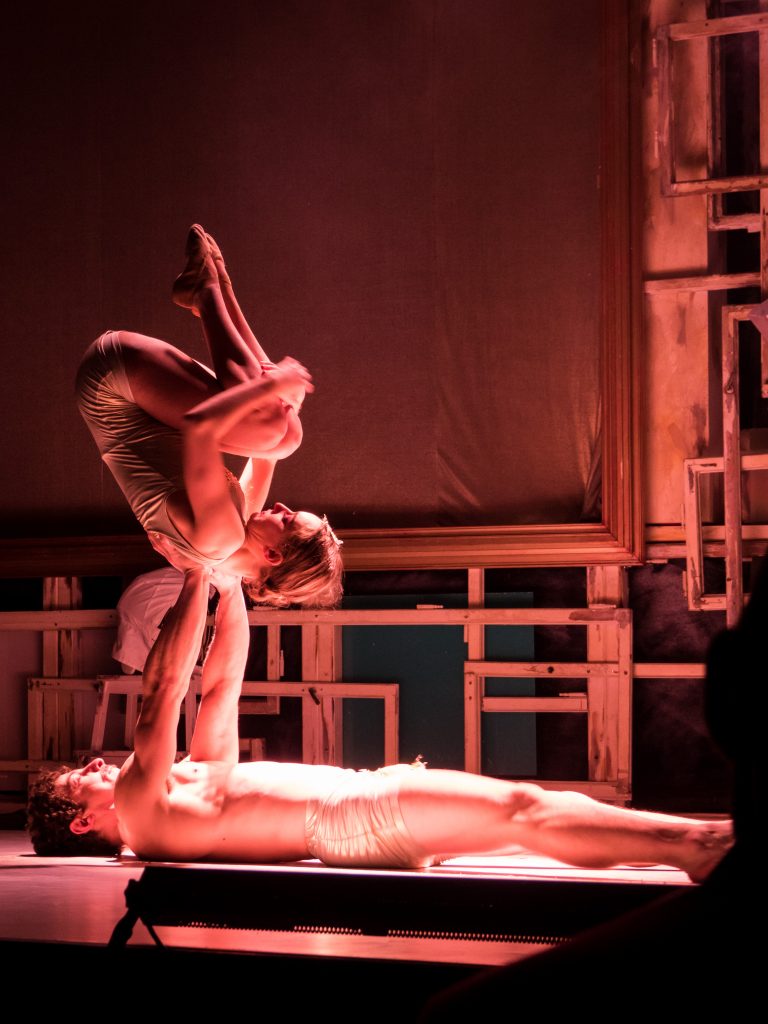 adam and eve perform partner physical theatre routine