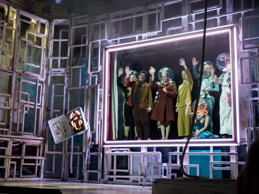the whole cast waves goodbye from the edge of the stage
